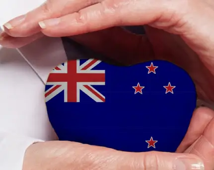 new-zealand-doctor-holding-heart-flag